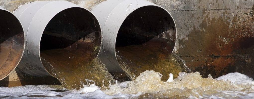 Pollution - website banner of toxic water as running from sewers to the environment