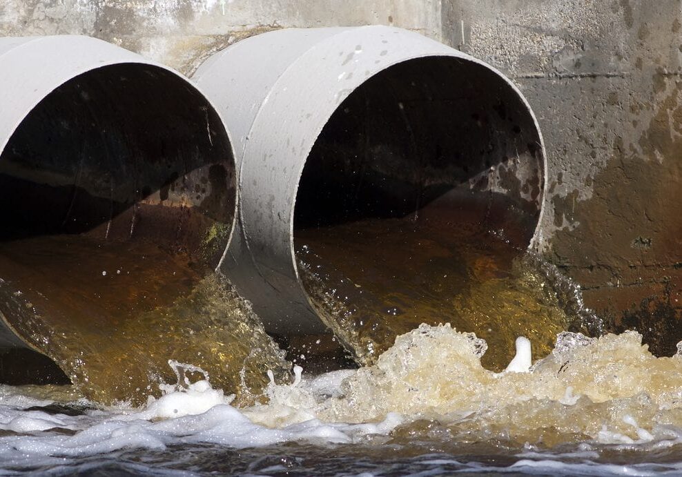 Pollution - website banner of toxic water as running from sewers to the environment